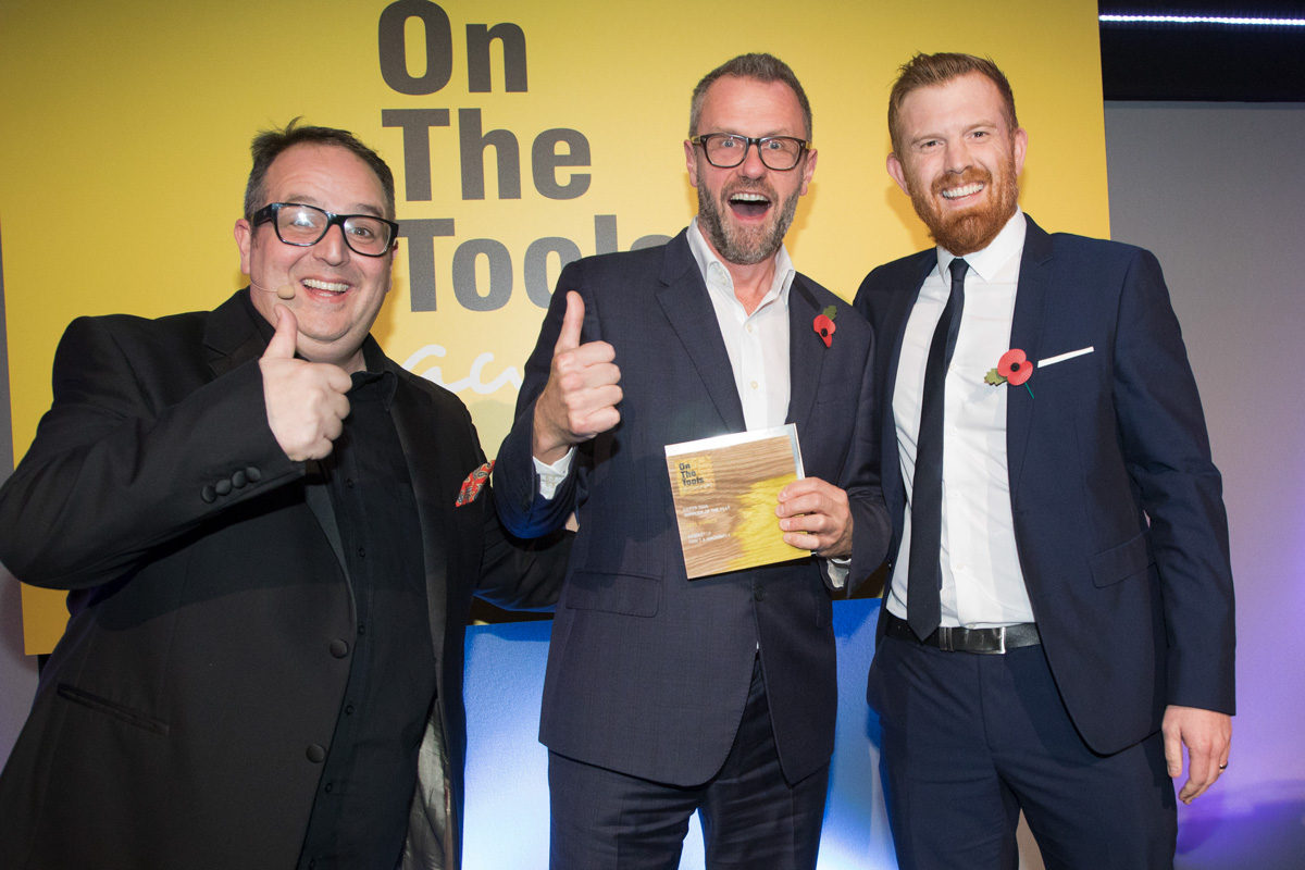 Axminster's Martin Brown (centre) jubilant at receiving the award from comedian/actor Justin Moorhouse (left) and Tony Munro (right) of sponsors Jewson. Image is courtesy of Don't Panic and Barney Newman Photography.