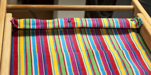 Tacking fabric to the frame of deckchair