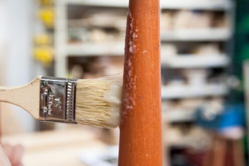 Applying the varnish stripper with a brush