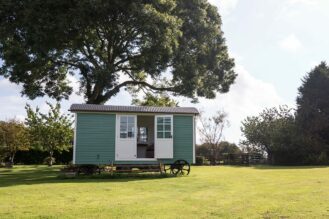 A completed Shepherds hut in an orchard