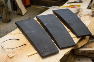 Three black pieces of finished oak