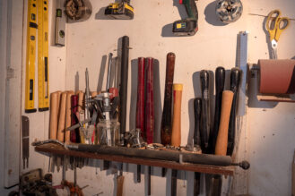 woodturning tools hung up on the wall of the workshop