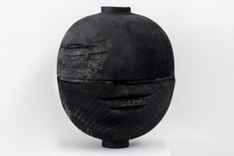 black charred wood turned vessel in exhibition