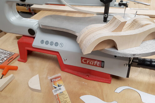 Cutting the car parts with a scroll saw