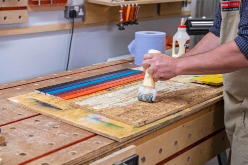Rolling an even coat of glue to the backing board